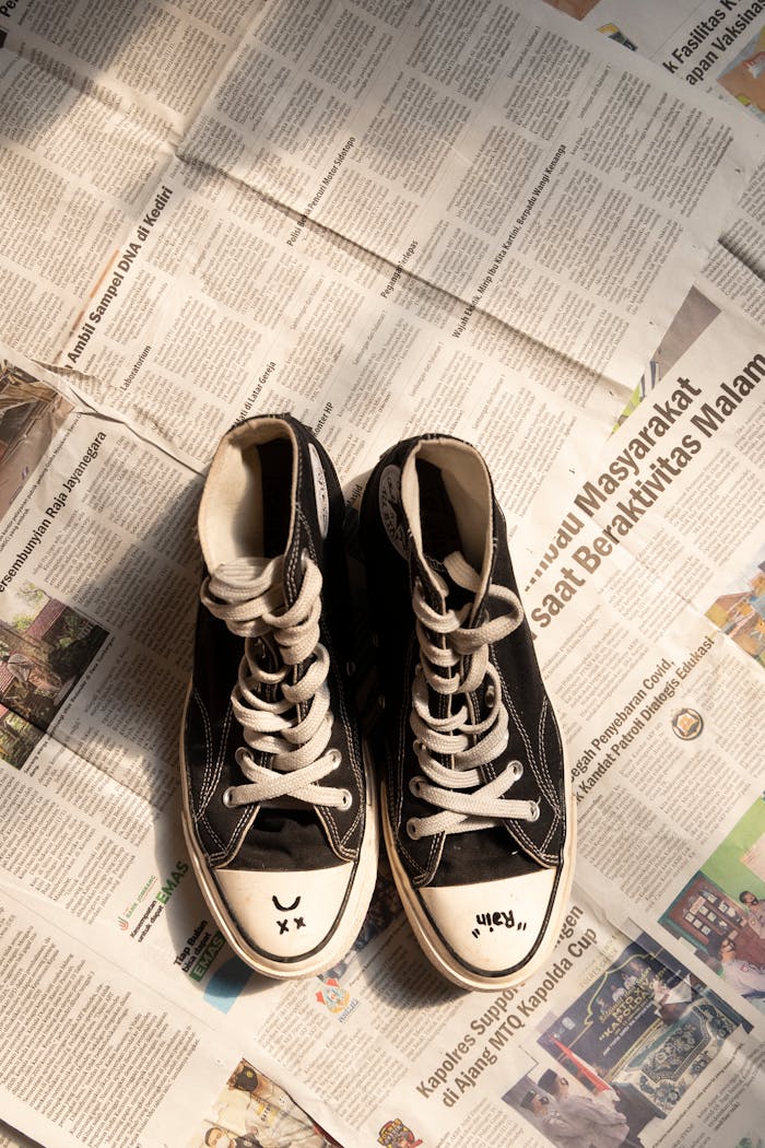 Black Sneakers on Newspapers